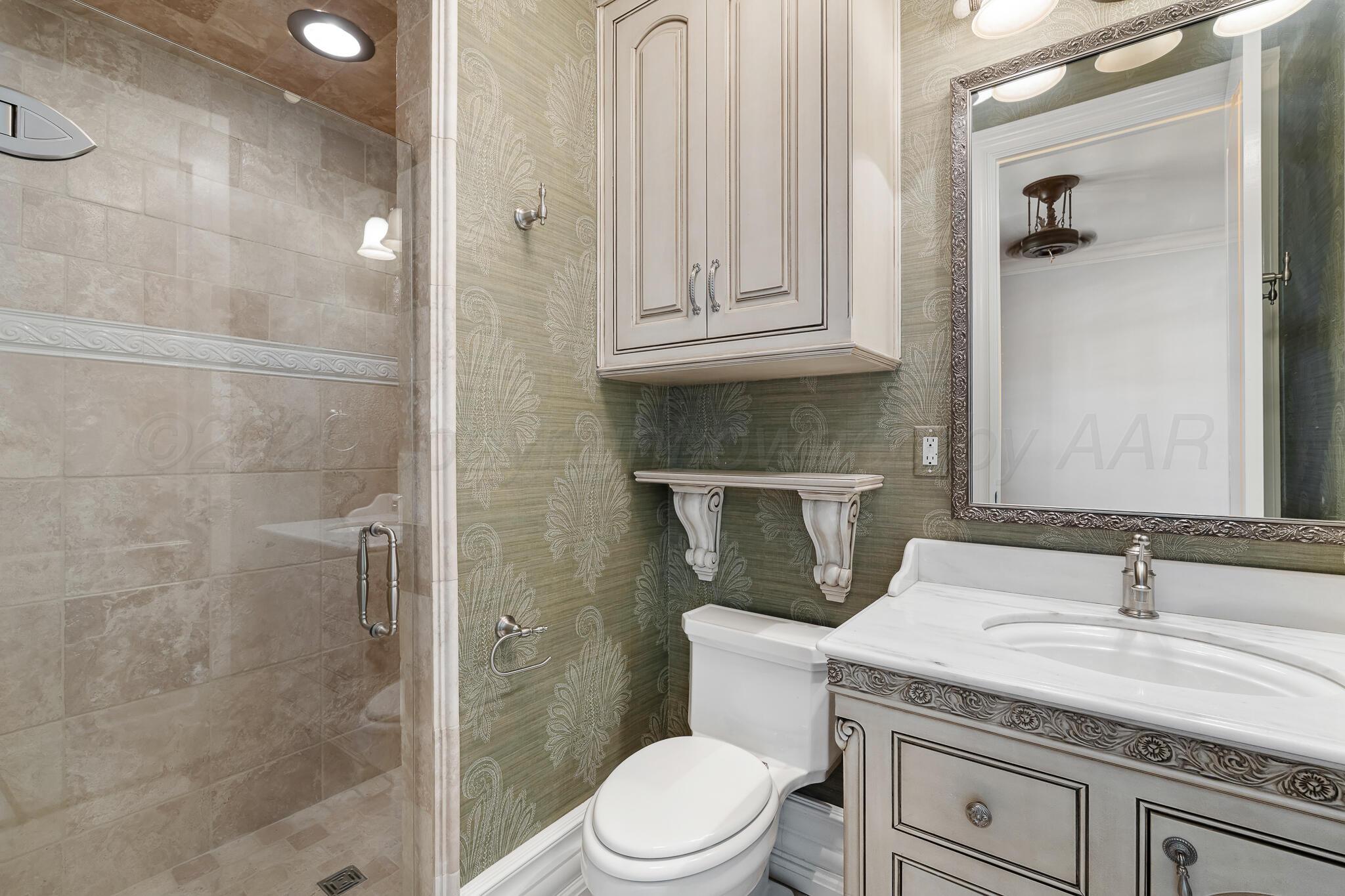 18 Cypress Point Amarillo, TX 79124 - Photo 59 of 95 a bathroom with a granite countertop sink a toilet and shower