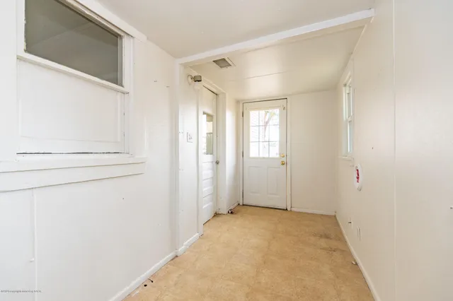 a view of a big room with closet and mirror