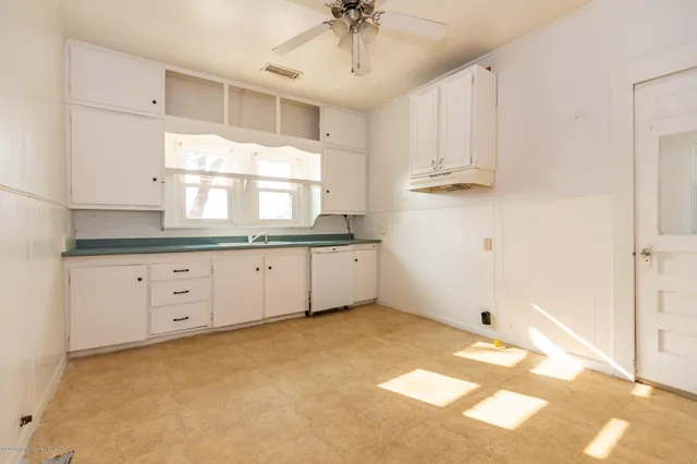 a kitchen with cabinets appliances and a counter space