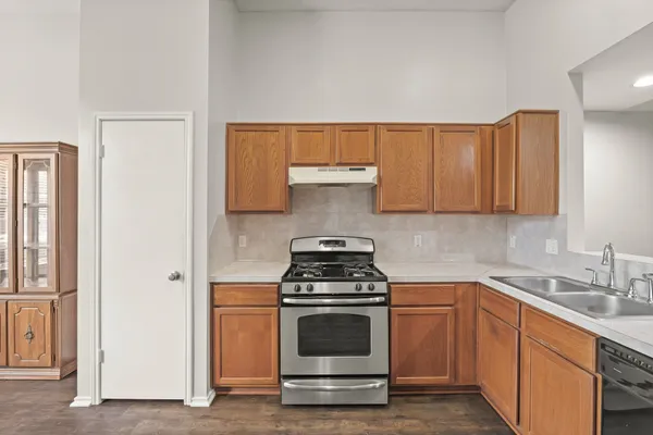 a kitchen with granite countertop a stove and a sink