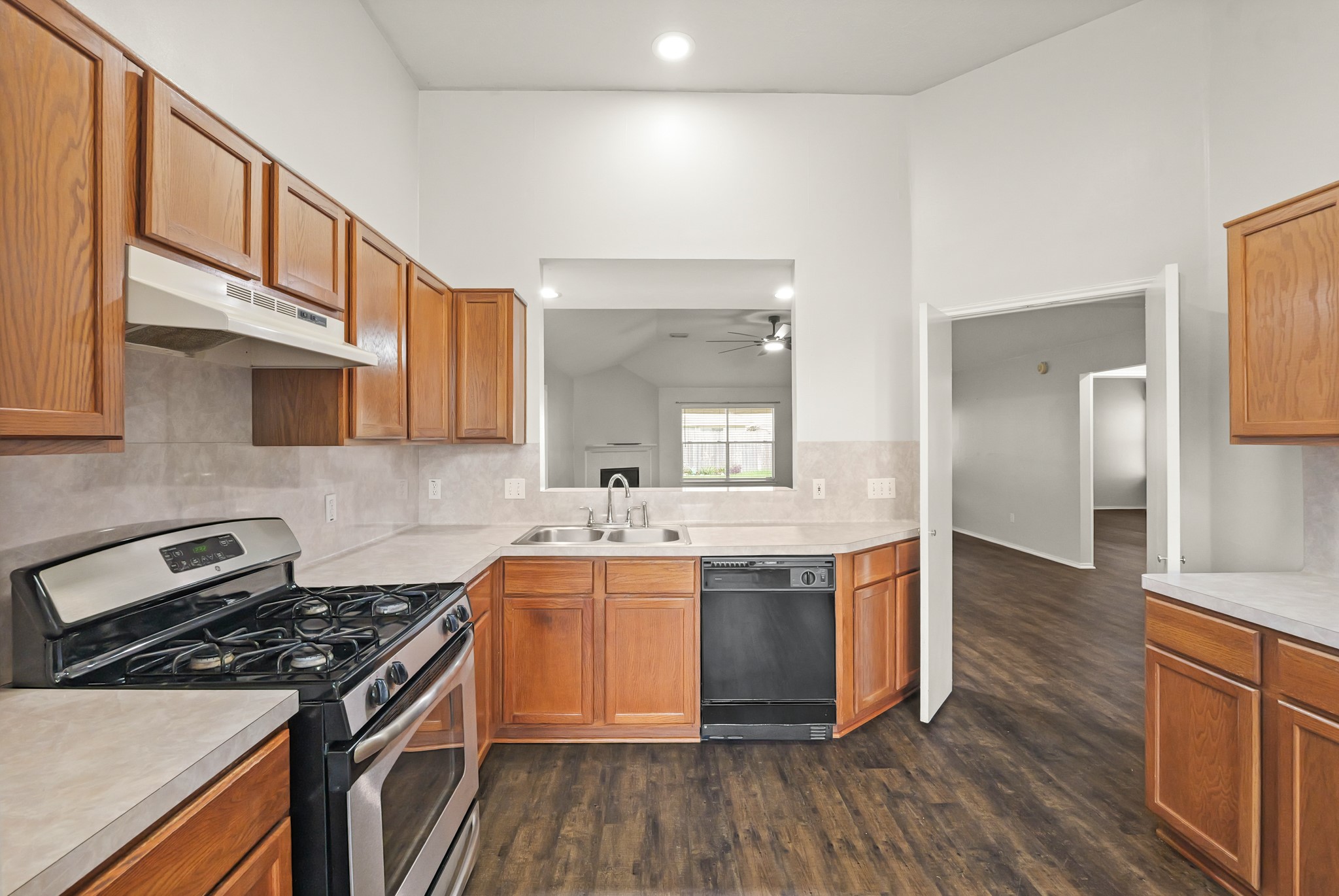 3651 Woodlace Drive Humble, TX 77396 - Photo 12 of 38 a kitchen with stainless steel appliances granite countertop a stove and a sink