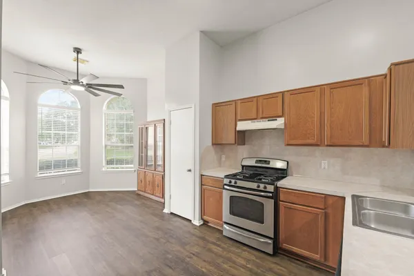 a kitchen with granite countertop a stove and a refrigerator