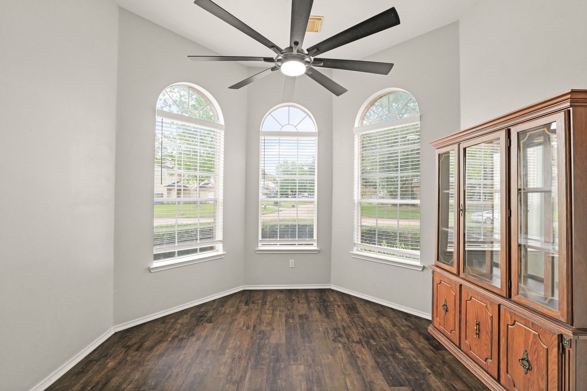3651 Woodlace Drive Humble, TX 77396 - Photo 16 of 38 an empty room with wooden floor fan and windows