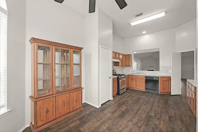 a large kitchen with a large window and stainless steel appliances