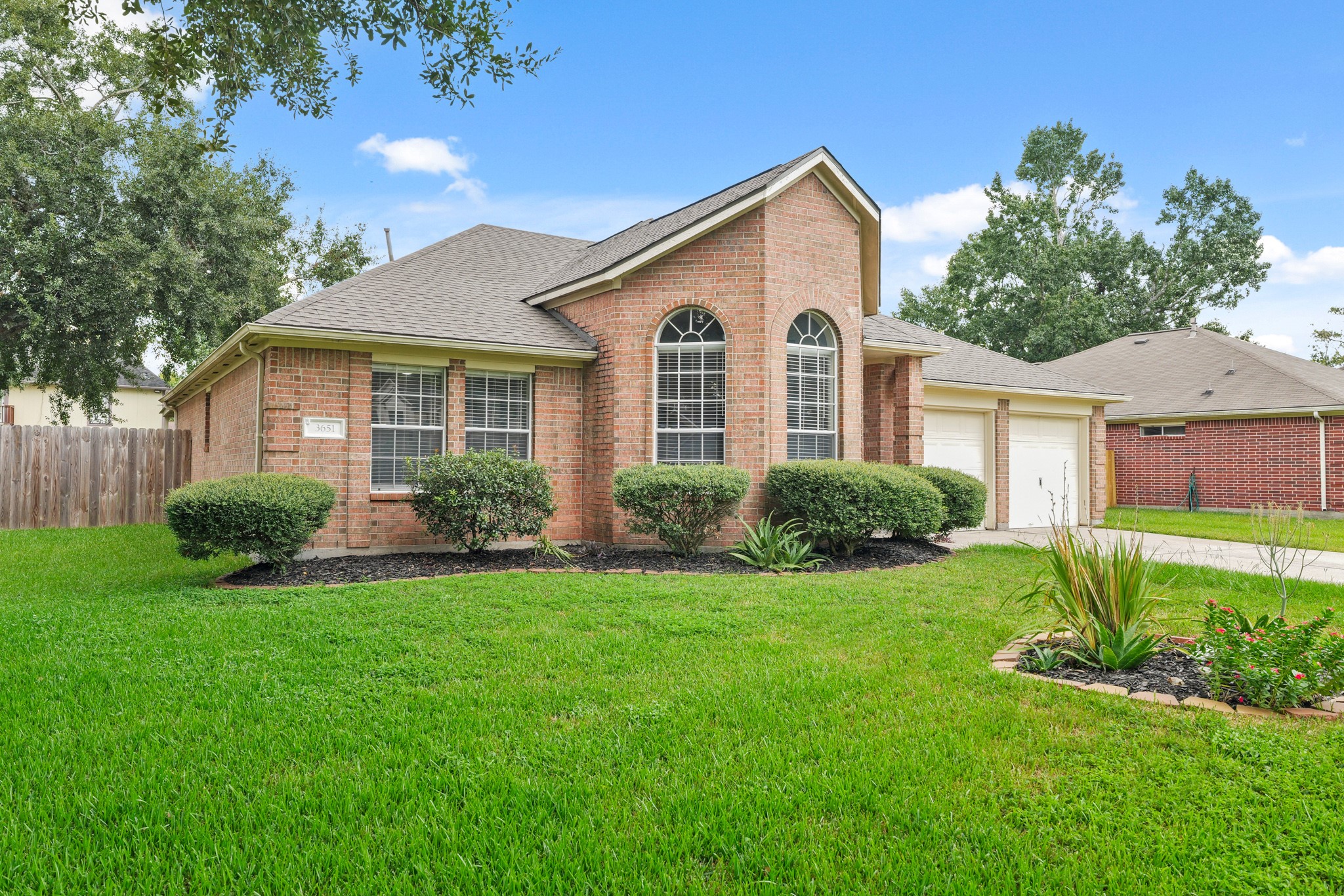 3651 Woodlace Drive Humble, TX 77396 - Photo 2 of 38 a view of a house with a yard and potted plants
