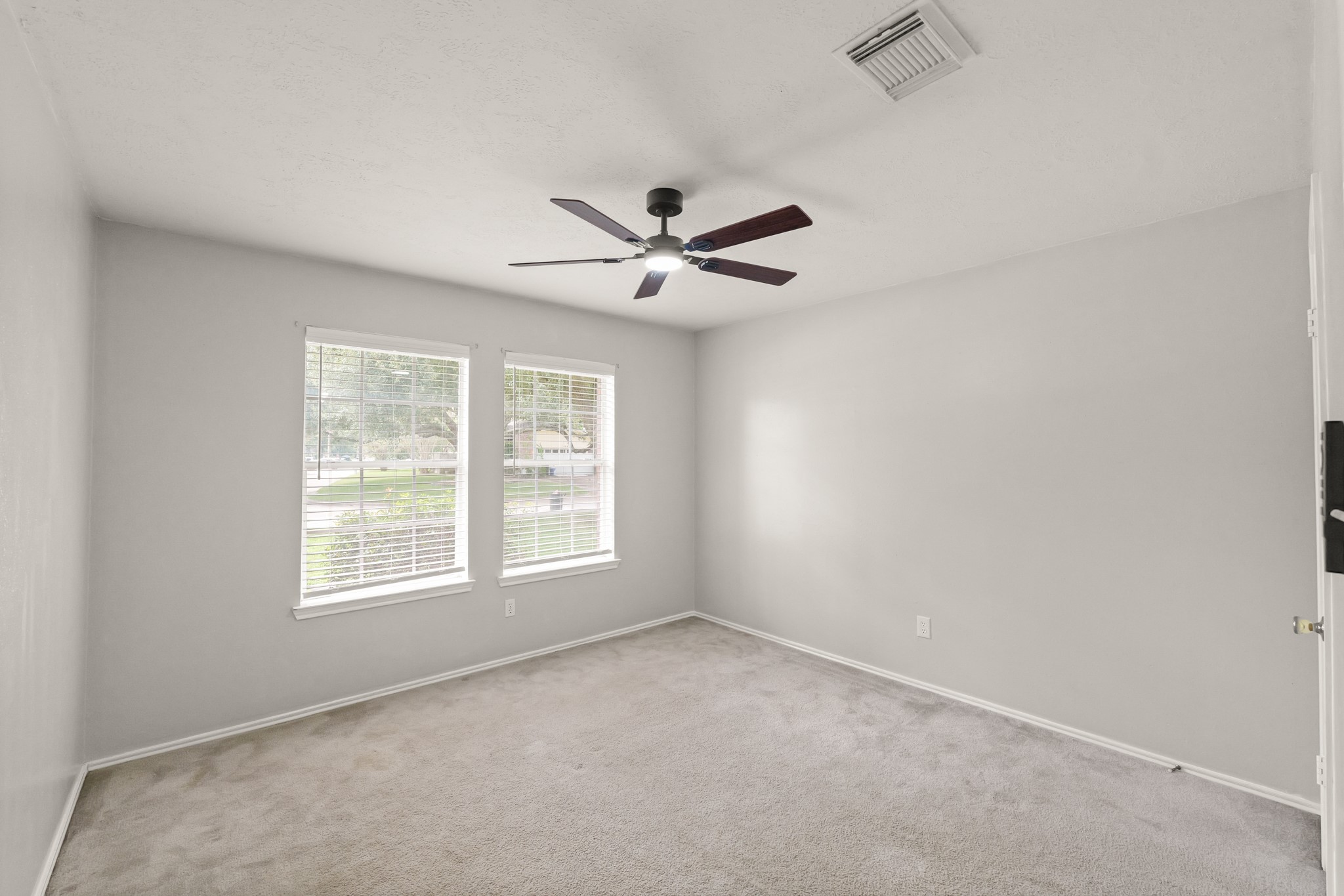 3651 Woodlace Drive Humble, TX 77396 - Photo 21 of 38 an empty room with windows and ceiling fan