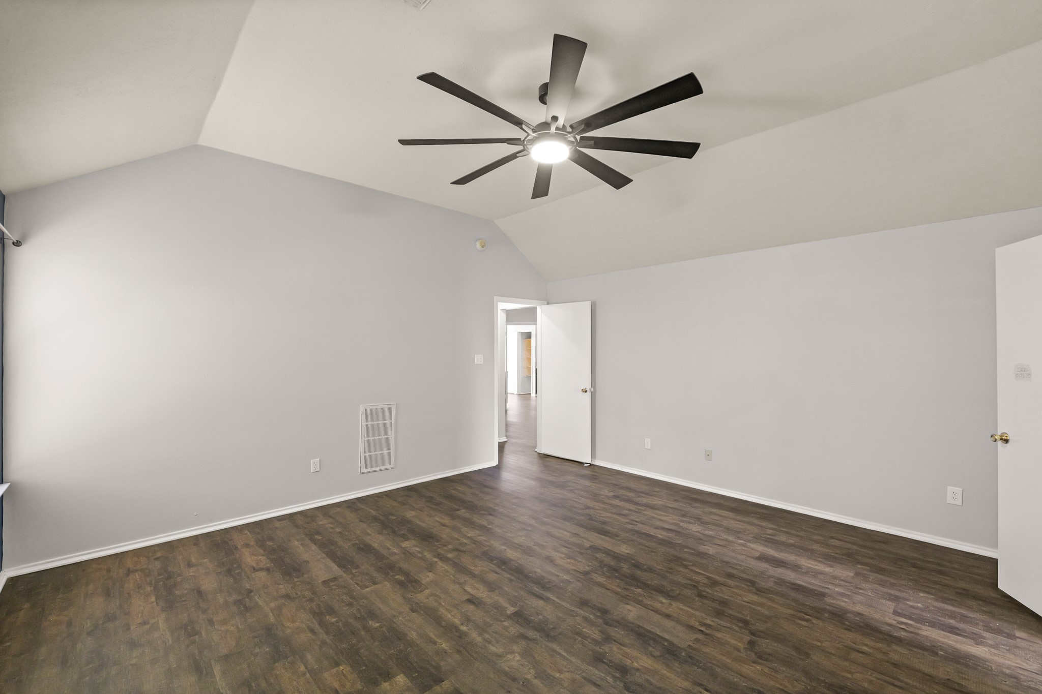 3651 Woodlace Drive Humble, TX 77396 - Photo 26 of 38 a view of an empty room with wooden floor and a ceiling fan