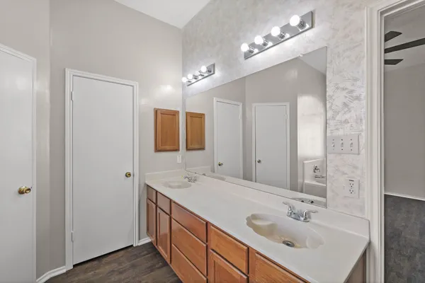 a bathroom with 2 sink and a mirror