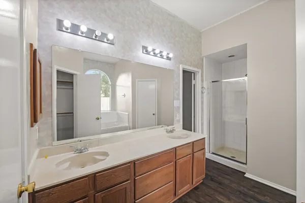 a bathroom with a double vanity sink and a mirror