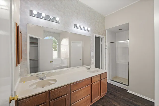 a bathroom with a double vanity sink and a mirror