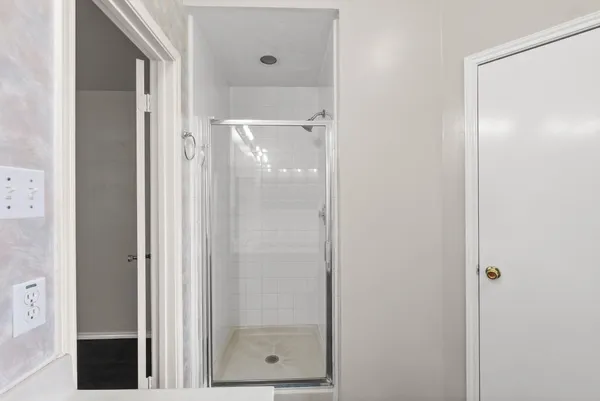 a bathroom with a glass shower door