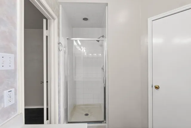 a bathroom with a glass shower door