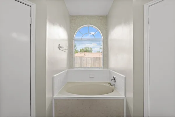 a bath tub sitting next to a white sink