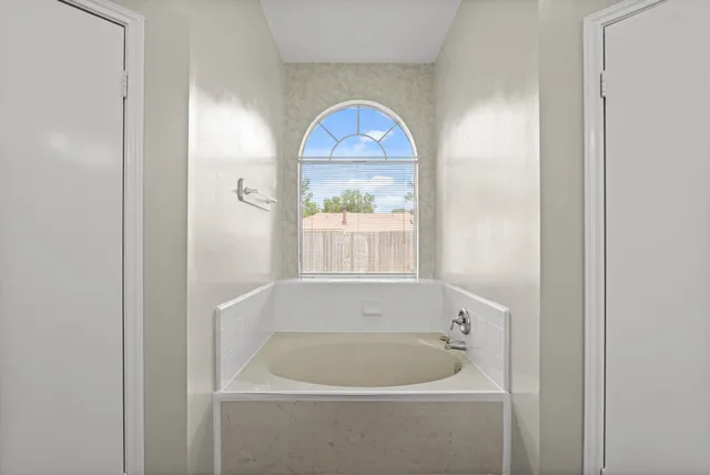 a bath tub sitting next to a white sink