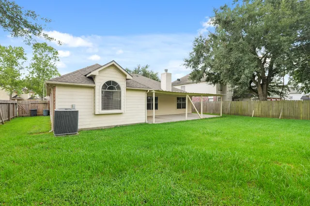 a front view of a house with yard and green space