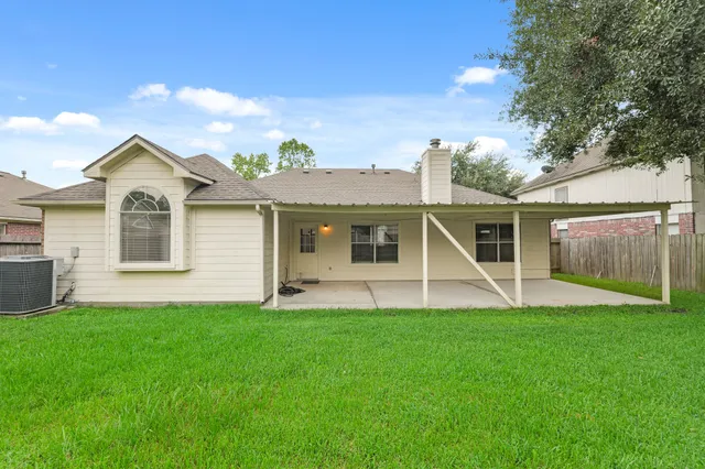 a view of a house with a yard and sitting area