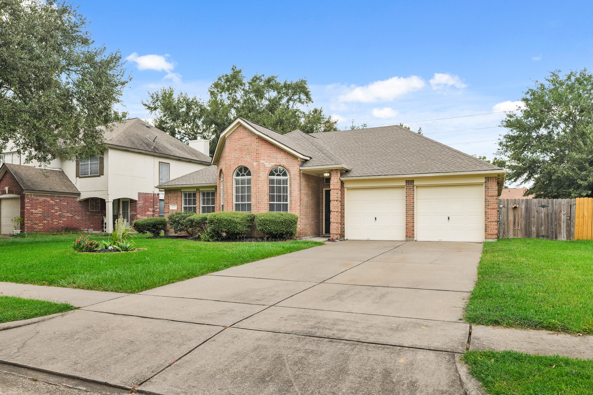3651 Woodlace Drive Humble, TX 77396 - Photo 5 of 38 a front view of a house with a yard and garage
