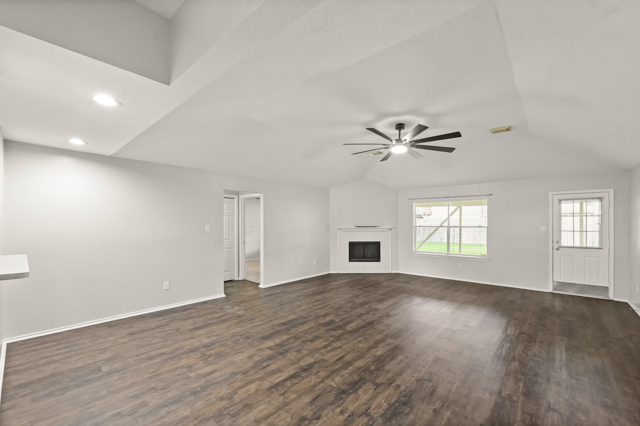 3651 Woodlace Drive Humble, TX 77396 - Photo 6 of 38 a view of an empty room with wooden floor and a window