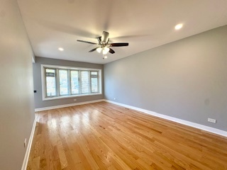 10353 South Spaulding Avenue Chicago, IL 60655 - Photo 5 of 21 an empty room with wooden floor and windows