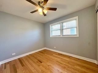 10353 South Spaulding Avenue Chicago, IL 60655 - Photo 10 of 21 a view of empty room with wooden floor and fan