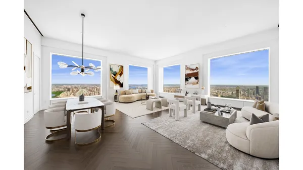 a living room with furniture a rug and white walls
