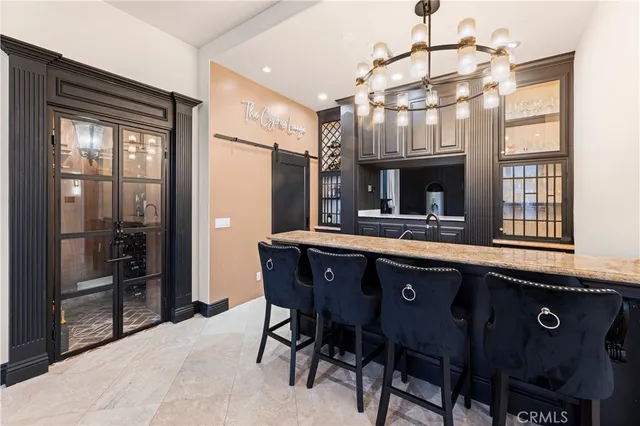a kitchen with a table chairs refrigerator and sink