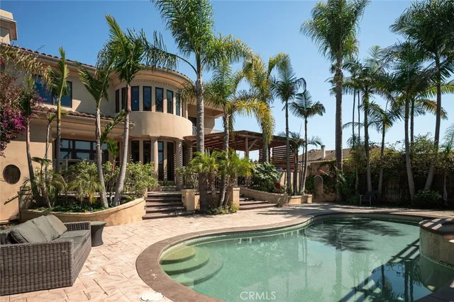 a view of a house with swimming pool and sitting area