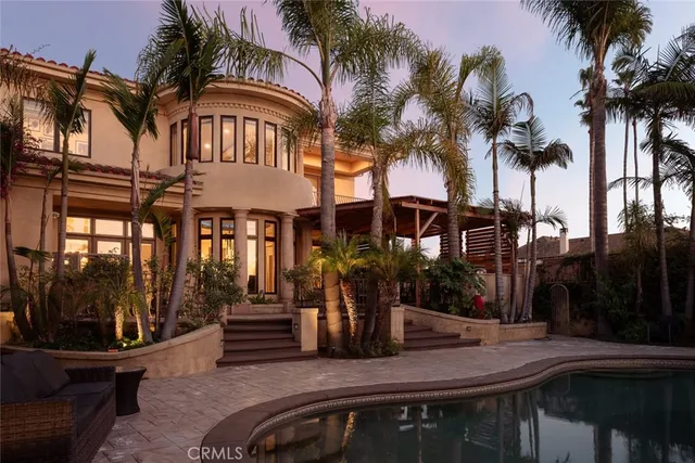 a front view of a house with swimming pool and glass windows