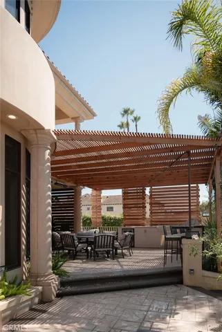 a view of a patio with couches table and chairs and potted plants