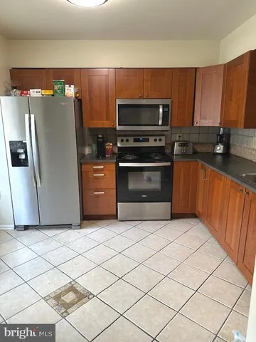 a kitchen with stainless steel appliances a stove a microwave and a refrigerator