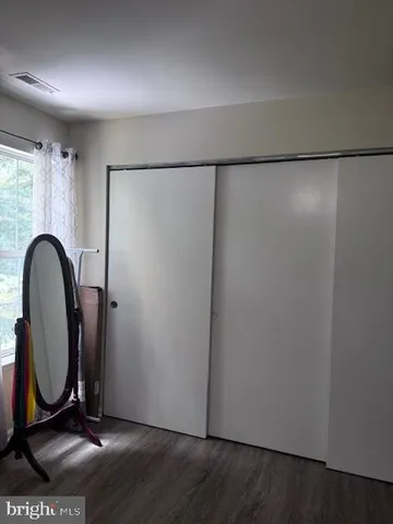 a white toilet sitting next to a white sink and vanity
