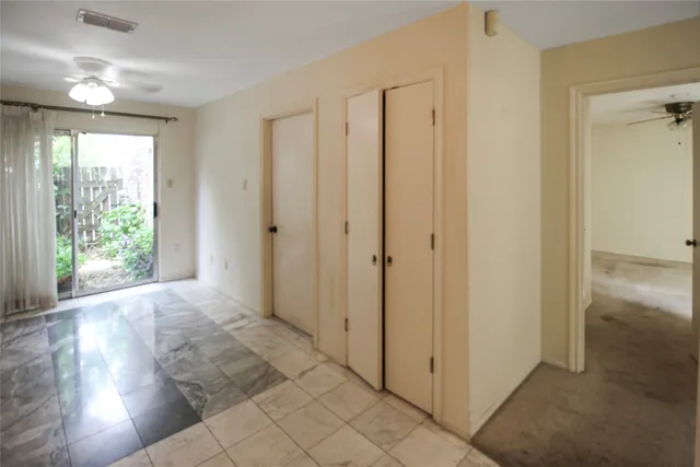a view of entryway with window and wooden floor