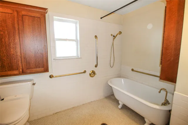 a white bath tub sitting next to a toilet