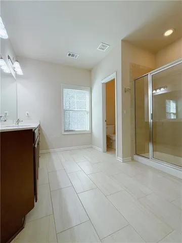 a view of an empty room with a fireplace and a window