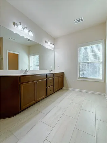 a bathroom with a sink vanity and mirror