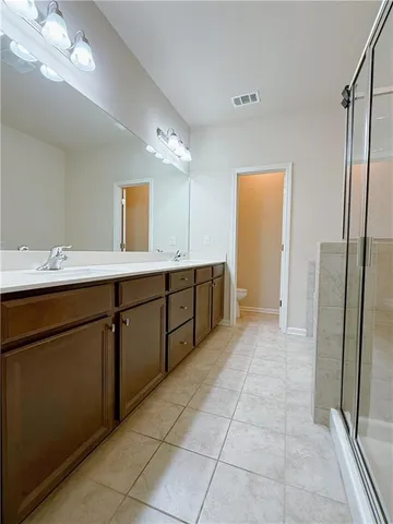 a spacious bathroom with a sink a mirror and a vanity