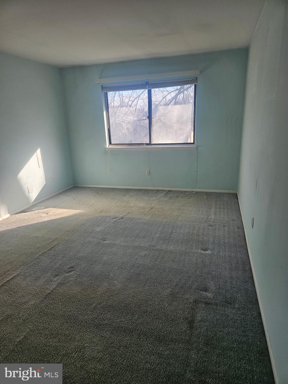 820A Putnam Boulevard, Unit 49B Wallingford, PA 19086 - Photo 4 of 11 a view of an empty room and window