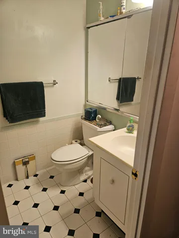a bathroom with a toilet a sink and a mirror