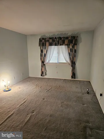 a view of room with a window and a ceiling fan