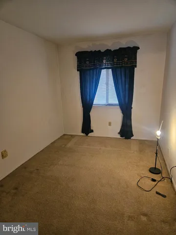 a view of an empty room with a fireplace