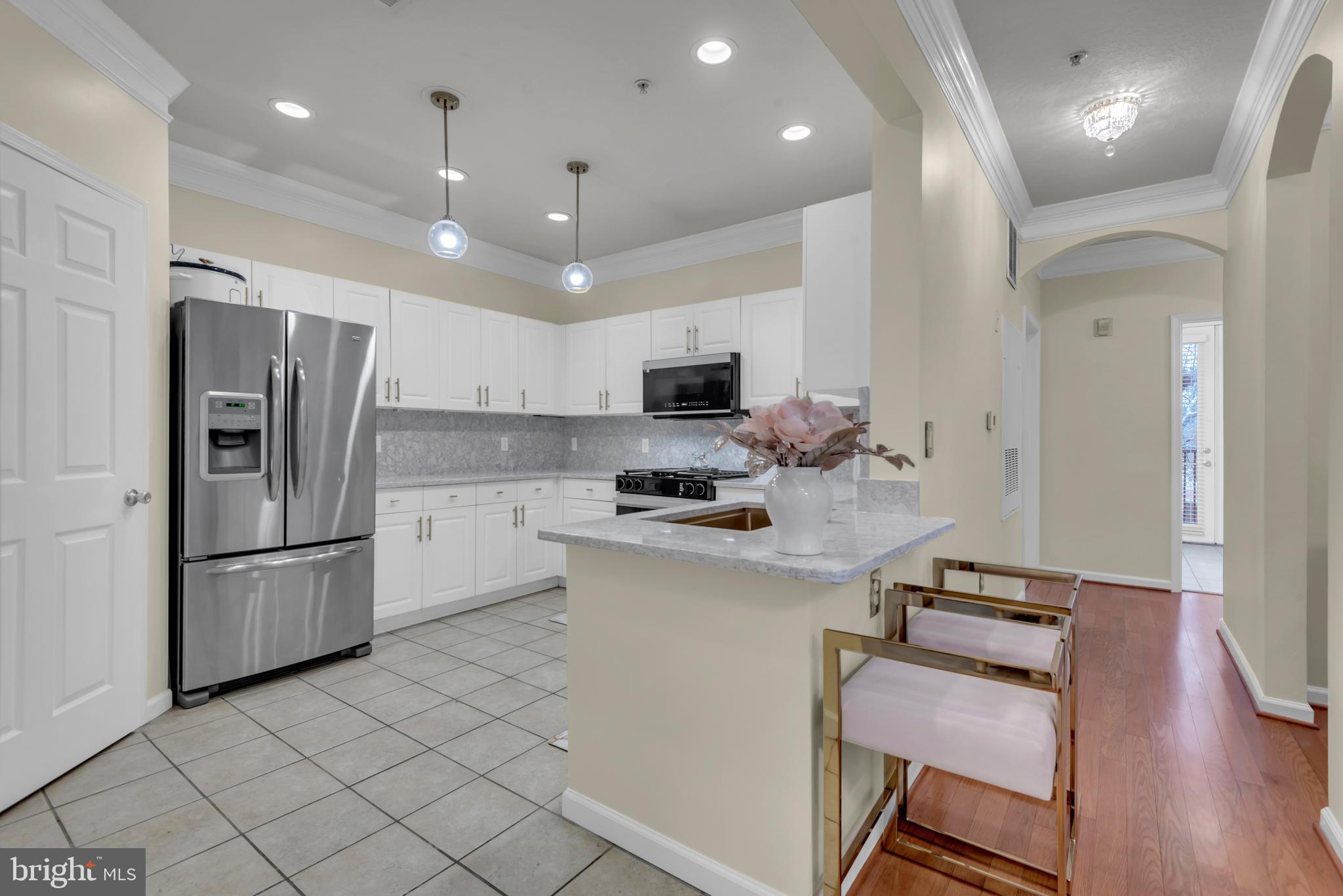7 Booth Street, Unit 302 Gaithersburg, MD 20878 - Photo 14 of 63 a kitchen with a refrigerator and a stove top oven