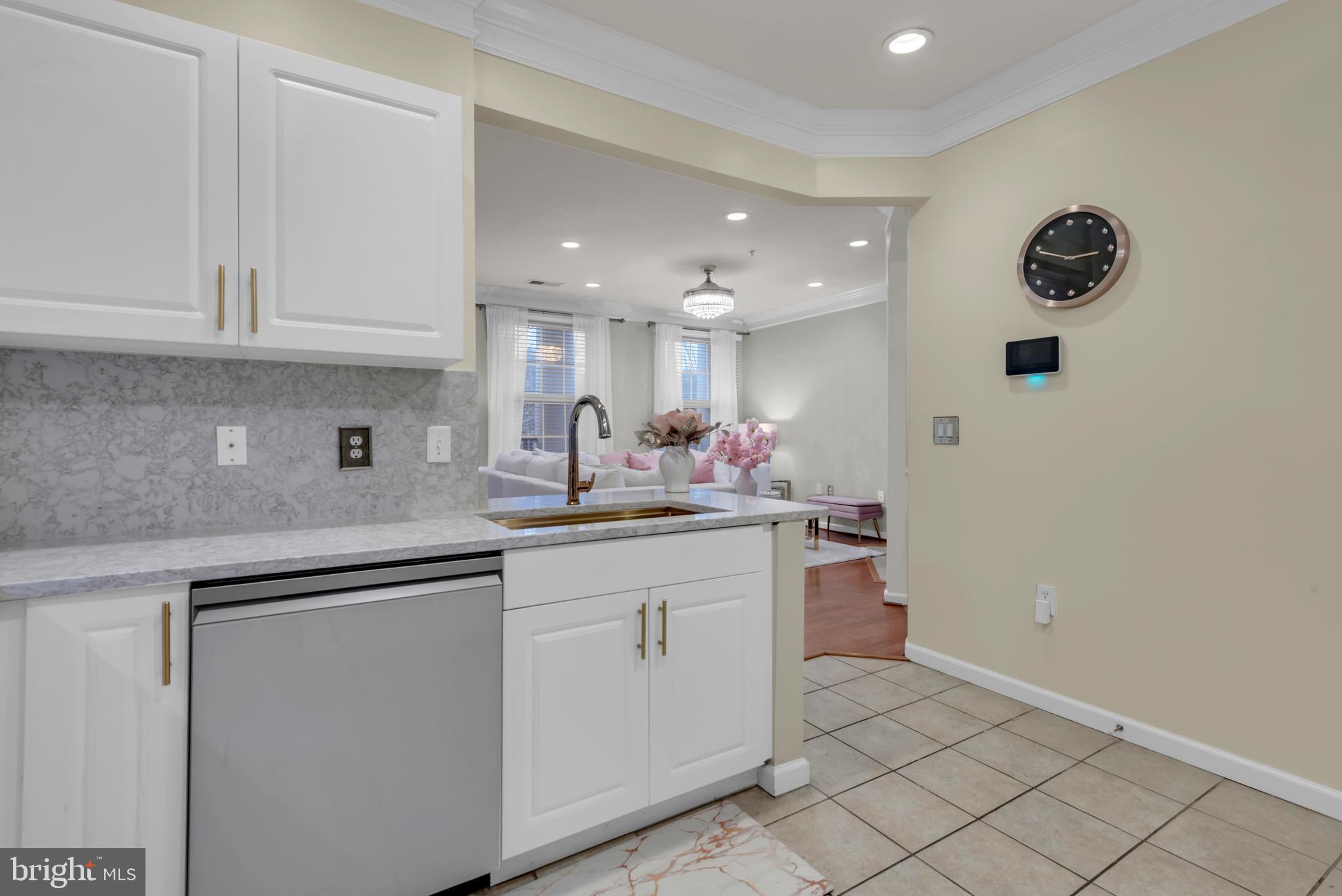 7 Booth Street, Unit 302 Gaithersburg, MD 20878 - Photo 18 of 63 a kitchen with a sink and cabinets