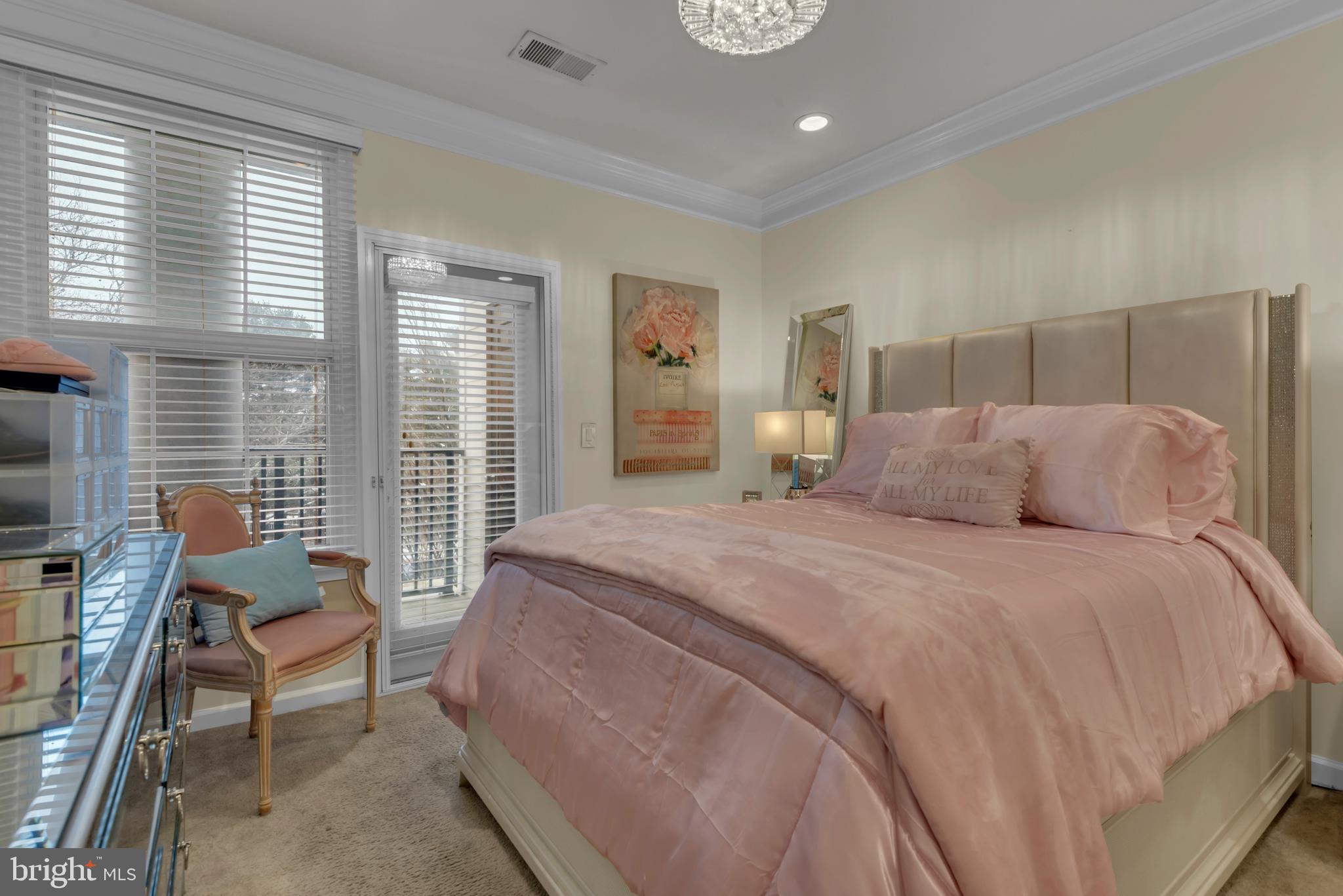 7 Booth Street, Unit 302 Gaithersburg, MD 20878 - Photo 20 of 63 a bedroom with a bed and large windows