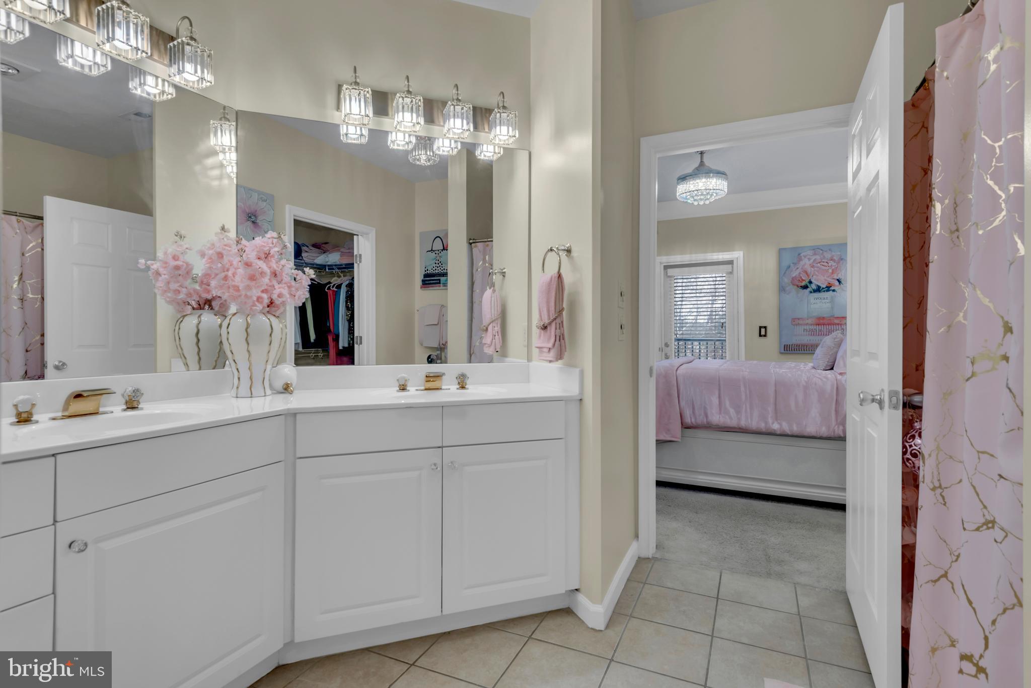 7 Booth Street, Unit 302 Gaithersburg, MD 20878 - Photo 23 of 63 a en suite bathroom with a double vanity sink and a mirror