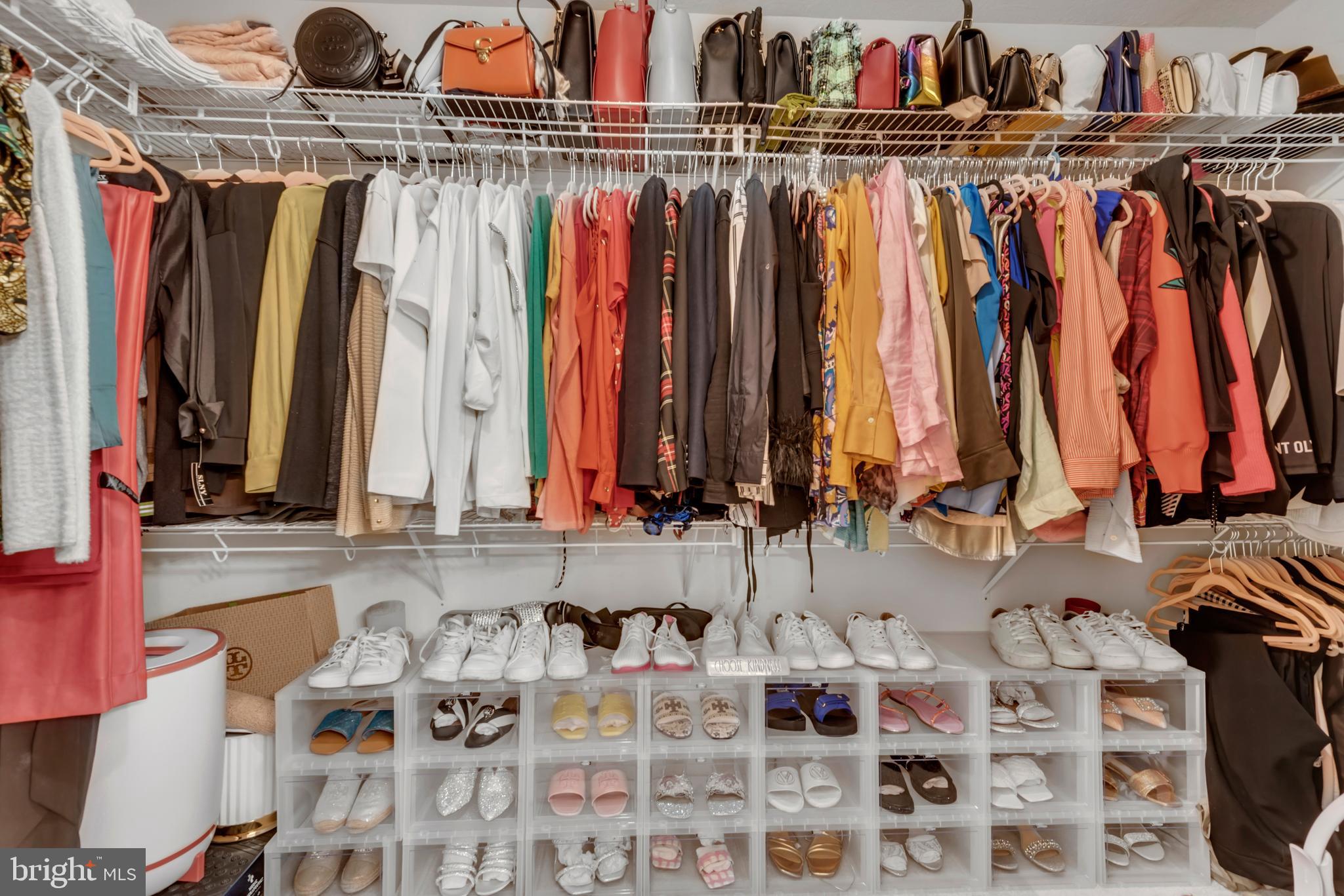 7 Booth Street, Unit 302 Gaithersburg, MD 20878 - Photo 24 of 63 a view of walk in closet with clothes and shoes