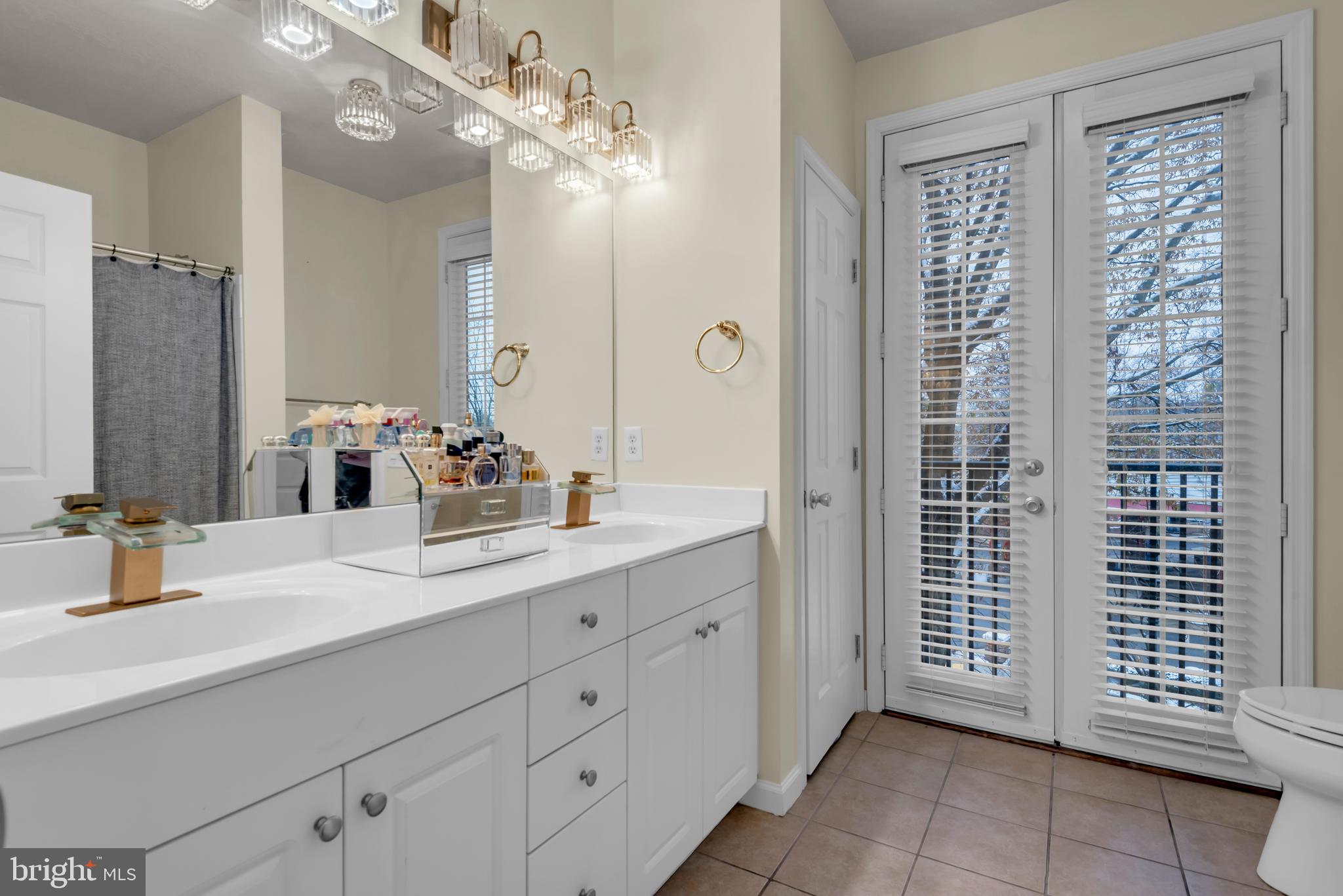 7 Booth Street, Unit 302 Gaithersburg, MD 20878 - Photo 30 of 63 a bathroom with a sink double vanity and a mirror