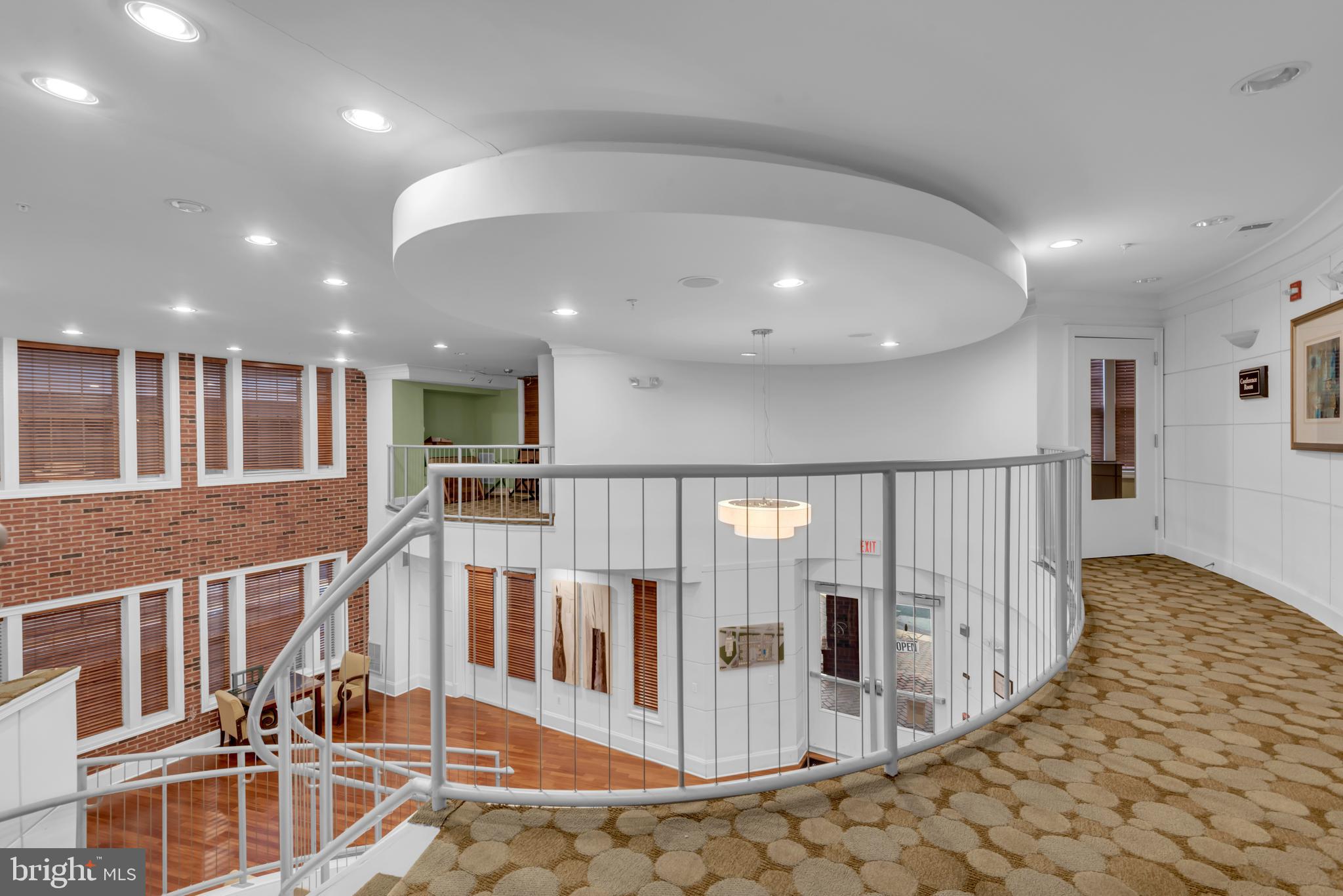 7 Booth Street, Unit 302 Gaithersburg, MD 20878 - Photo 42 of 63 a view of a hallway with wooden floor and windows