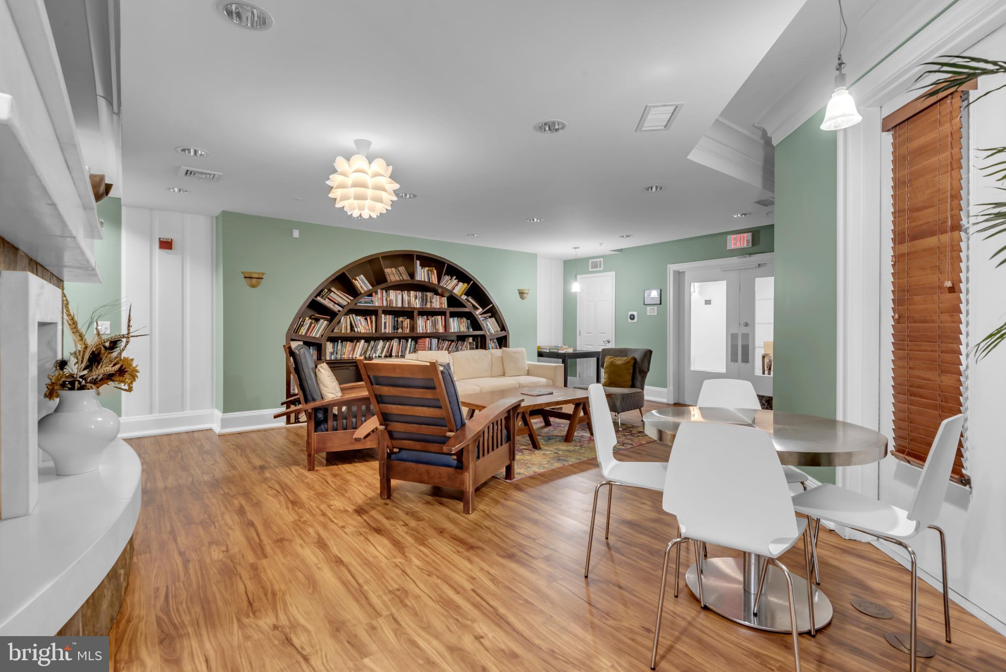 7 Booth Street, Unit 302 Gaithersburg, MD 20878 - Photo 55 of 63 a living room with furniture a rug and a wooden floor