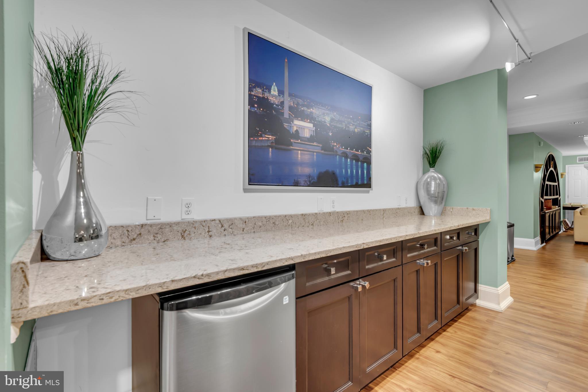 7 Booth Street, Unit 302 Gaithersburg, MD 20878 - Photo 57 of 63 a kitchen with stainless steel appliances granite countertop a sink a stove with wooden floor