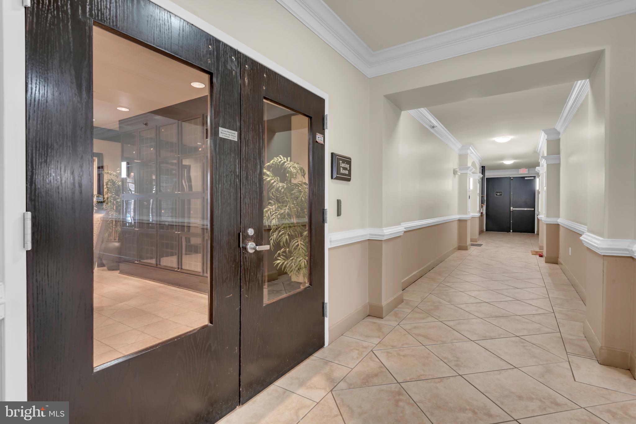 7 Booth Street, Unit 302 Gaithersburg, MD 20878 - Photo 58 of 63 a view of a hallway with windows and chandelier